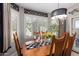 Bright dining space with shuttered windows, accent wall trim, and modern light fixture, perfect for entertaining at 18867 N Cactus Flower Way, Surprise, AZ 85387
