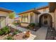 Charming front of house with an arched entry, meticulously designed landscaping, and a well-maintained walkway at 18867 N Cactus Flower Way, Surprise, AZ 85387