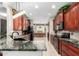 Well-appointed kitchen with granite countertops, black appliances, and dark wood cabinetry at 18867 N Cactus Flower Way, Surprise, AZ 85387