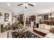 Open living room with a bar and kitchen featuring tile flooring and stylish décor at 18867 N Cactus Flower Way, Surprise, AZ 85387