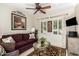 Cozy living room features a comfortable sofa, decorative art, and bright windows with views of the surrounding landscape at 18867 N Cactus Flower Way, Surprise, AZ 85387