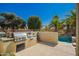 Outdoor kitchen featuring a built-in grill and counter space, perfect for entertaining in the backyard near the splash pool at 18867 N Cactus Flower Way, Surprise, AZ 85387