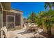 Outdoor patio area with comfortable seating under the shade of tropical palms, ideal for relaxation and entertaining at 18867 N Cactus Flower Way, Surprise, AZ 85387