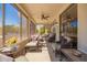 Inviting screened-in patio with comfortable seating, a ceiling fan, and views of the beautiful outdoor landscape at 18867 N Cactus Flower Way, Surprise, AZ 85387