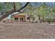 Large backyard with covered patio, ceiling fan, desert landscaping, and mature shade trees at 20838 N 39Th Dr, Glendale, AZ 85308