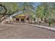View of backyard featuring desert landscaping, rock path, and mature trees at 20838 N 39Th Dr, Glendale, AZ 85308