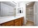 Well-lit bathroom with a single sink vanity and a glass-enclosed shower at 20838 N 39Th Dr, Glendale, AZ 85308
