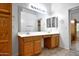 Bathroom with double vanity, framed mirrors and updated lighting at 20838 N 39Th Dr, Glendale, AZ 85308