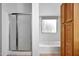 Bathroom featuring a shower, bathtub, and built in storage shelves at 20838 N 39Th Dr, Glendale, AZ 85308