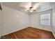 Comfortable bedroom boasting wood floors, a ceiling fan, and a bright window at 20838 N 39Th Dr, Glendale, AZ 85308