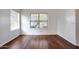 Bright bedroom with wood floors, white walls, and natural light through a window at 20838 N 39Th Dr, Glendale, AZ 85308