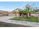 Charming single-story home featuring a well-manicured lawn and a three-car garage for convenience at 20838 N 39Th Dr, Glendale, AZ 85308
