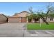 Charming single-story home featuring a well-manicured lawn and a three-car garage for convenience at 20838 N 39Th Dr, Glendale, AZ 85308