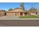 Charming single-story home featuring a well-maintained front yard and a convenient two-car garage at 20838 N 39Th Dr, Glendale, AZ 85308