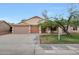 Charming single-story home featuring a well-manicured lawn and a three-car garage for convenience at 20838 N 39Th Dr, Glendale, AZ 85308