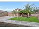 Charming single-story home featuring a well-manicured lawn, a two-car garage, and a welcoming entrance at 20838 N 39Th Dr, Glendale, AZ 85308