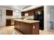 Well-equipped kitchen showcasing dark wood cabinets, stainless steel appliances, and a center island at 20838 N 39Th Dr, Glendale, AZ 85308