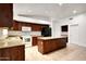 Large kitchen featuring a center island, dark wood cabinets, and stainless steel appliances at 20838 N 39Th Dr, Glendale, AZ 85308