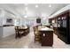 Open-concept kitchen flowing into the dining area with a granite island and modern appliances at 20838 N 39Th Dr, Glendale, AZ 85308