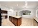 Kitchen with central island, tile floors, and easy access to the dining area at 20838 N 39Th Dr, Glendale, AZ 85308