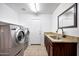 Laundry room with new washer and dryer, cabinets and tile floor at 20838 N 39Th Dr, Glendale, AZ 85308