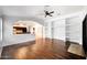 Bright living room featuring hardwood floors, ceiling fan, and built-in shelving for stylish decor at 20838 N 39Th Dr, Glendale, AZ 85308
