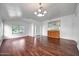Open-concept living room featuring wood floors, neutral paint, and stylish light fixtures at 20838 N 39Th Dr, Glendale, AZ 85308