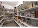 Walk-in pantry with abundant white shelving offering lots of storage for food, supplies, and other household needs at 20838 N 39Th Dr, Glendale, AZ 85308