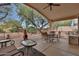 Covered patio with comfortable seating, a fire pit, and a view of the landscaped backyard at 20838 N 39Th Dr, Glendale, AZ 85308