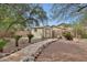 Well-maintained backyard storage shed with a stone pathway, complemented by desert-friendly landscaping at 20838 N 39Th Dr, Glendale, AZ 85308