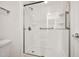 Modern shower with grab bars and a transparent glass door, offering a sleek and accessible design at 20838 N 39Th Dr, Glendale, AZ 85308