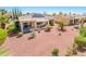 Spacious backyard featuring a covered patio, desert landscaping, and modern solar panels on the roof at 22236 N Arrellaga Dr, Sun City West, AZ 85375