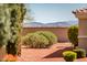 Backyard with desert landscaping and picturesque mountain views in the distance at 22236 N Arrellaga Dr, Sun City West, AZ 85375