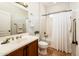 Cozy bathroom featuring a vanity, tile floor, and white shower curtain at 22236 N Arrellaga Dr, Sun City West, AZ 85375