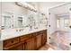 Bathroom showcasing double sinks, a vanity, and tile flooring, adjacent to the Primary bedroom at 22236 N Arrellaga Dr, Sun City West, AZ 85375