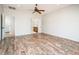 Bedroom with ensuite bathroom featuring wood-look floors and white walls at 22236 N Arrellaga Dr, Sun City West, AZ 85375