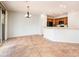 Bright dining area with tile flooring, modern chandelier, and sliding glass doors leading to the outdoor patio at 22236 N Arrellaga Dr, Sun City West, AZ 85375