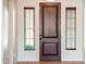 Inviting entryway with a solid wood door, sidelight windows, and stylish tile flooring at 22236 N Arrellaga Dr, Sun City West, AZ 85375