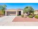 Charming single-story home featuring a two-car garage, desert landscaping, and a cozy front porch at 22236 N Arrellaga Dr, Sun City West, AZ 85375