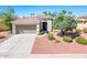Attractive single-story home with well-maintained desert landscaping, a two-car garage and a tile roof at 22236 N Arrellaga Dr, Sun City West, AZ 85375