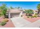 Inviting one-story home with a large driveway, desert landscaping, and a well-maintained tile roof at 22236 N Arrellaga Dr, Sun City West, AZ 85375