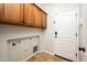 Well-equipped laundry room with ample cabinet storage and convenient utility connections at 22236 N Arrellaga Dr, Sun City West, AZ 85375