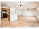 Spacious open-concept living room showcasing tile flooring, recessed lighting, and seamless flow into the kitchen area at 22236 N Arrellaga Dr, Sun City West, AZ 85375