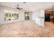 Open living room featuring tile floors, a ceiling fan, and a large window with a view of the desert landscape at 22236 N Arrellaga Dr, Sun City West, AZ 85375