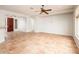 Expansive living room featuring tile flooring, neutral walls, a ceiling fan and natural light at 22236 N Arrellaga Dr, Sun City West, AZ 85375