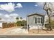 Gray home with black window shutters, desert landscaping, and a large driveway at 255 S 92Nd Pl, Mesa, AZ 85208