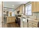 Bright kitchen with modern appliances, wooden cabinets, and an open design to the rest of the home at 255 S 92Nd Pl, Mesa, AZ 85208