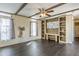 Open-concept living room with decorative beams and a built-in entertainment center with shelves at 255 S 92Nd Pl, Mesa, AZ 85208