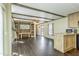 Open concept living space showcasing a built-in entertainment center, kitchen, and modern flooring at 255 S 92Nd Pl, Mesa, AZ 85208