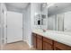 Bathroom featuring a single sink vanity with dark wood cabinets and a large mirror at 25536 W Primrose Ln, Buckeye, AZ 85326